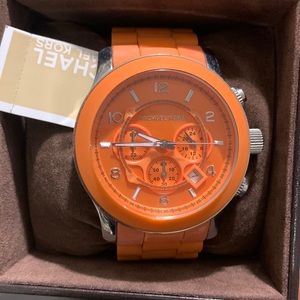 Michael Kors watch with tags, book, and box